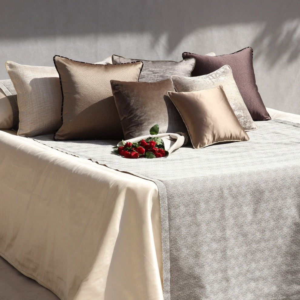 beige and white silk bedspread